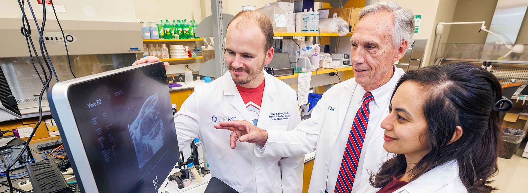 A new generation of physiologists tapping into the expertise of Dr. John Hall, center, include, from left, Dr. Alan Mouton and Dr. Ana Omoto. Both are UMMC assistant professors of physiology and biophysics.